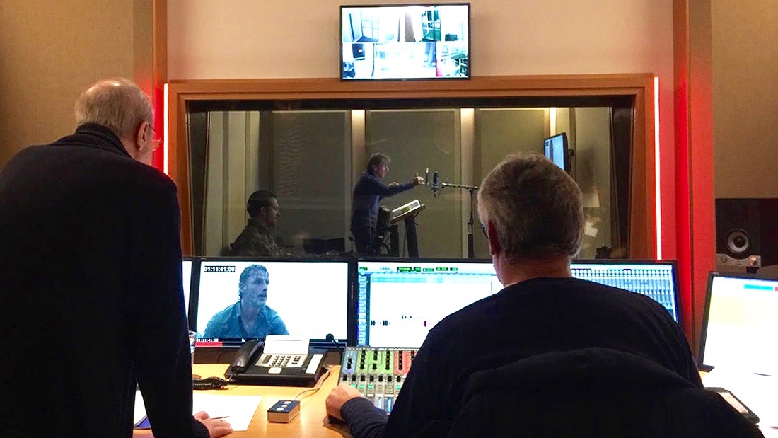 Inside the EuroSync studios in Berlin, German voice actor Victor Neumann (far center) voices the part of Rick Grimes on The Walking Dead, while dubbing director Hans-Jürgen Wolf and an engineer look on. Inside the EuroSync studios in Berlin, German voice actor Victor Neumann (far center) voices the part of Rick Grimes on The Walking Dead, while dubbing director Hans-Jürgen Wolf and an engineer look on.